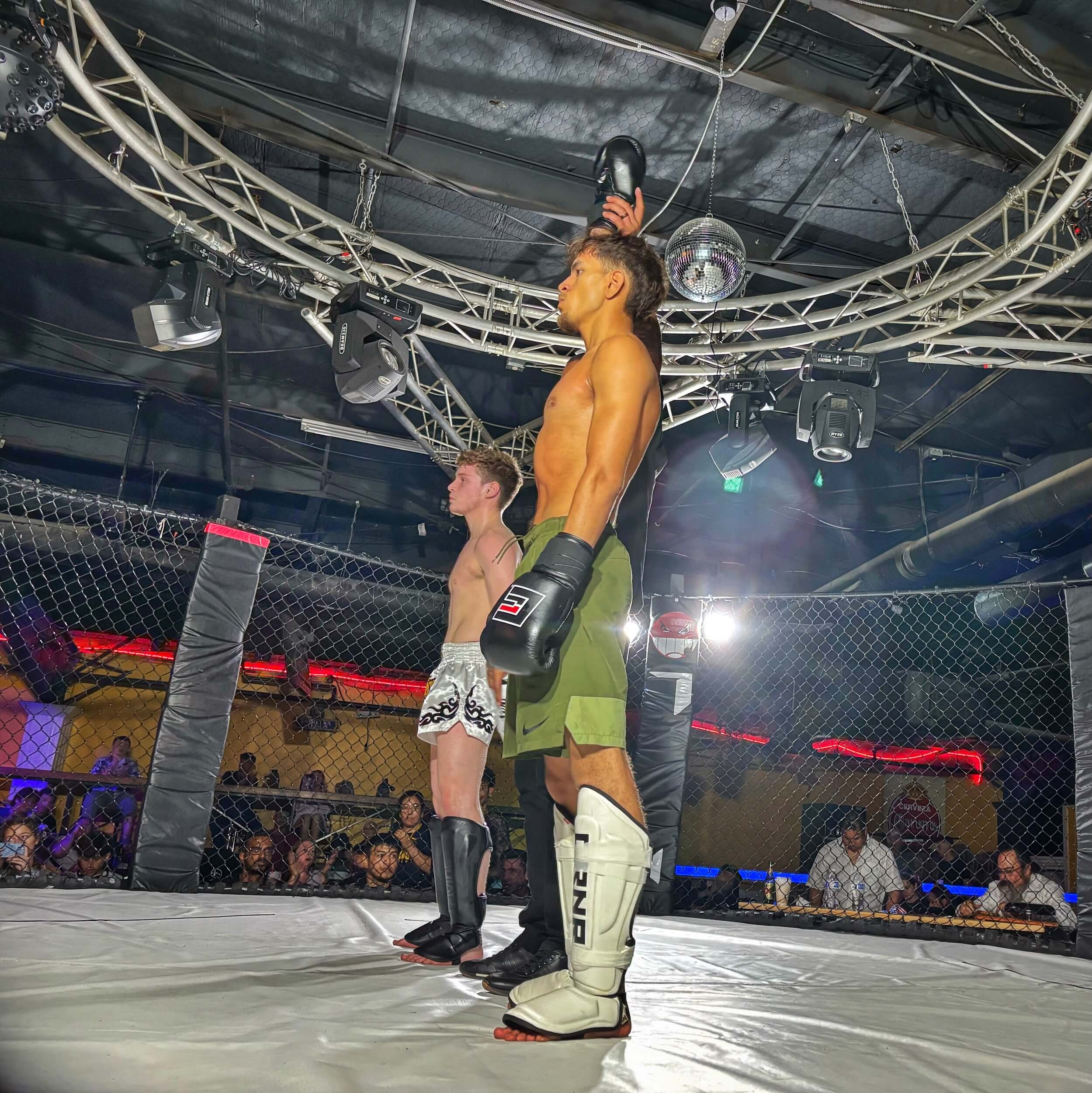 Martial Arts of Waco student raising hand in victory after winning MMA sparring match at competition.