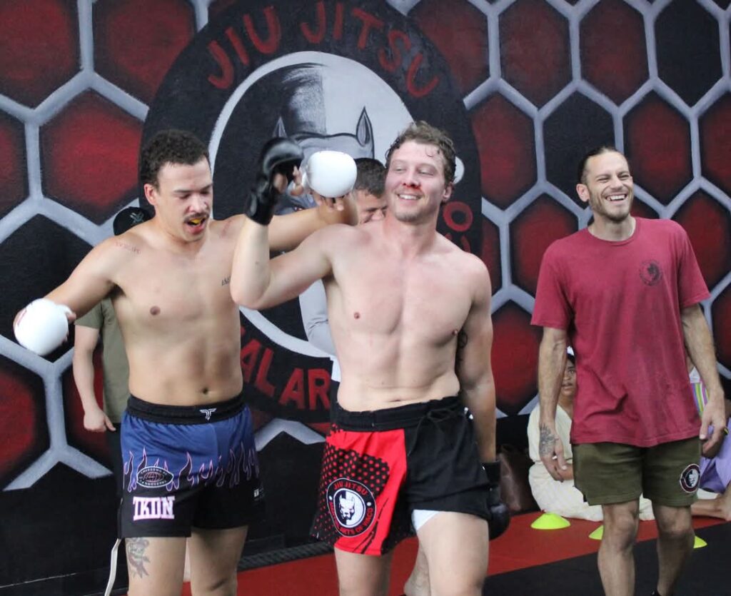 Martial Arts of Waco student walking away from a match victorious wearing sparring gear during MMA class.